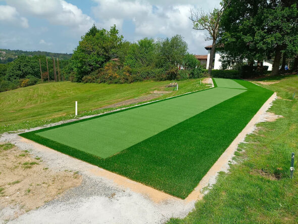 Kennewick Outdoor tee line consisting of one continuous green synthetic grass strip surrounded by trees